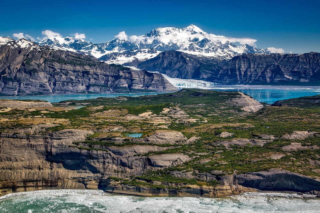 Mount St. Elias in Wrangell, Alaska, towering over a pristine wilderness with rugged peaks and snow-covered slopes.